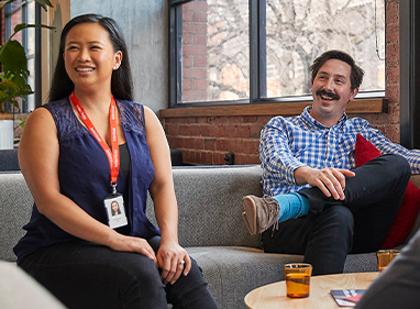 Female and male Lifeblood colleagues engaging in group conversation